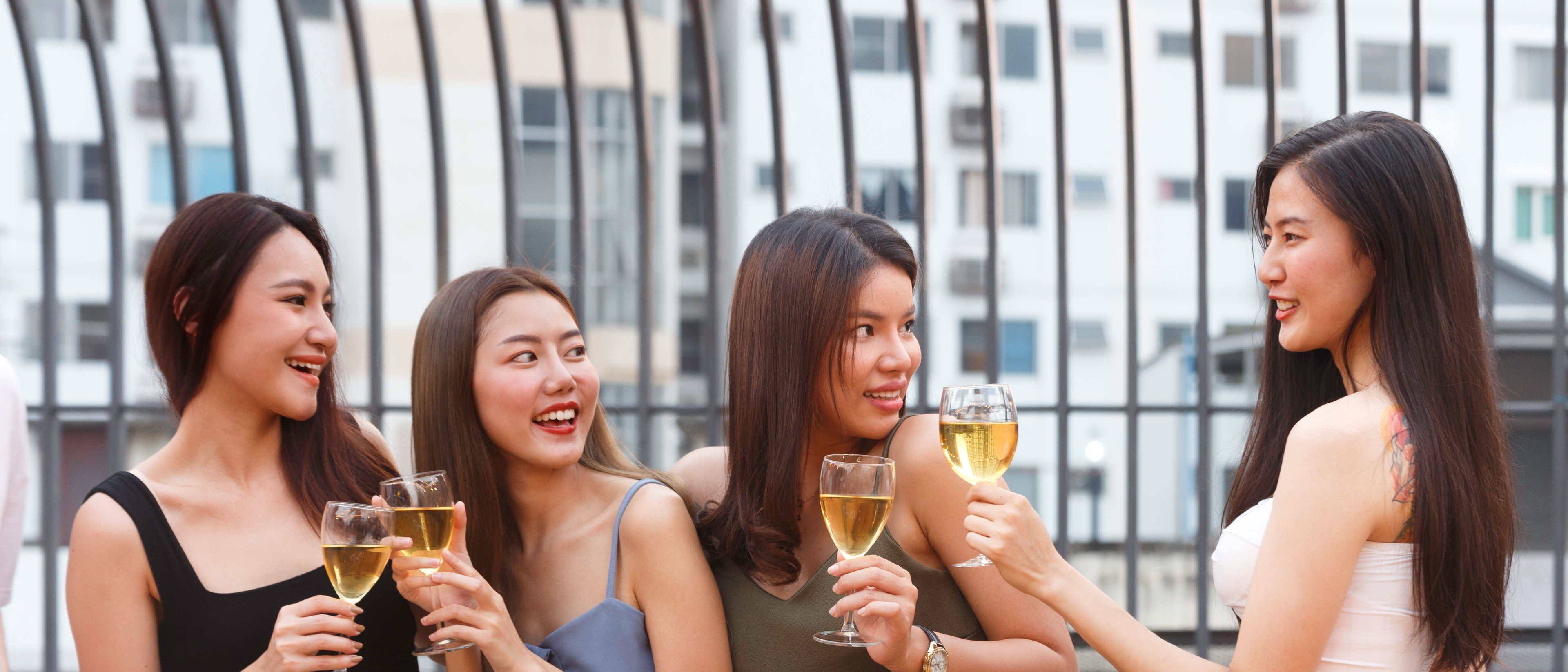 teenagers cheering and toast with white sparkling wine glass.